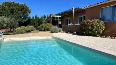 a swimming pool in front of a house at La Villa Tanamera, très jolie maison piscine, à 2 pas du centre-ville in Bédoin