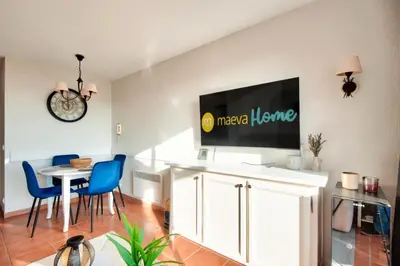 a living room with a tv on a wall at Village Pont Royal en Provence - maeva Home - Appartement climatisé 2 pièces 4 personnes - Sélection MAE-2601 in Mallemort