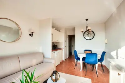 a living room with a couch and a table and chairs at Village Pont Royal en Provence - maeva Home - Appartement climatisé 2 pièces 4 personnes - Sélection MAE-2601 in Mallemort
