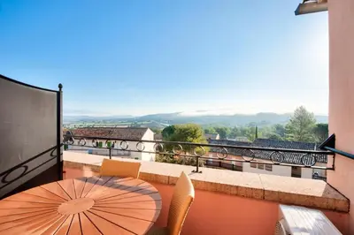 a balcony with a table and an umbrella at Village Pont Royal en Provence - maeva Home - Appartement climatisé 2 pièces 4 personnes - Sélection MAE-2601 in Mallemort