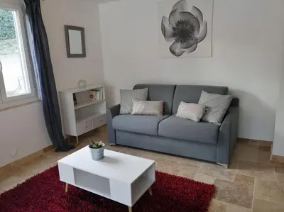 a living room with a couch and a coffee table at Joli studio calme et moderne in Pertuis