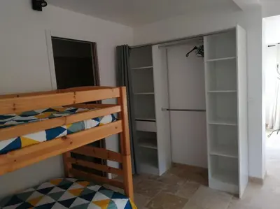a bedroom with a bunk bed and a closet at Joli studio calme et moderne in Pertuis
