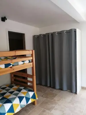 a room with a black shower curtain and a bunk bed at Joli studio calme et moderne in Pertuis