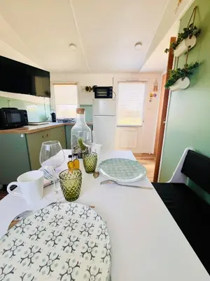 a kitchen with a table with bowls on it at Cabane la Clef des Champs au Mas des Entrages in Salon-de-Provence