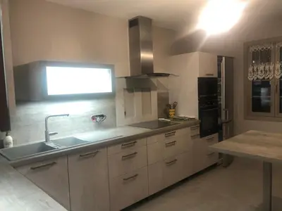 a kitchen with a sink and a counter top at VILLA AVEC PISCINE in Roussillon