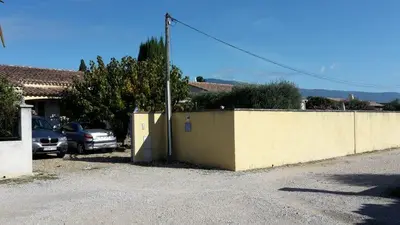 a car parked in a parking lot next to a fence at Provence Vaucluse Ventoux Villa Caromb in Caromb