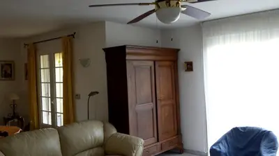 a living room with a couch and a ceiling fan at Provence Vaucluse Ventoux Villa Caromb in Caromb