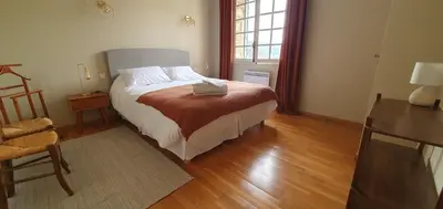 a bedroom with a bed and a wooden floor at Bastide le Seigneur in Sault-de-Vaucluse