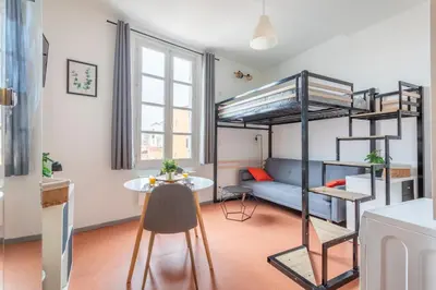 a small apartment with a bunk bed and a table at Studio calme et lumineux in Aix-en-Provence