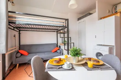 a living room with a table and a couch at Studio calme et lumineux in Aix-en-Provence