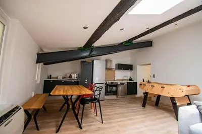 a kitchen with a table and ping pong tables in a room at Moderne et lumineux - clim - wifi in Aix-en-Provence