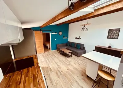 a living room with a couch and a table at Ô Sorgue in LʼIsle-sur-la-Sorgue