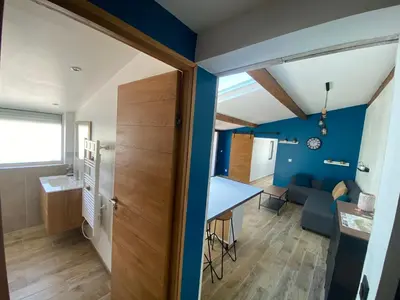 a small apartment with a blue accent wall at Ô Sorgue in LʼIsle-sur-la-Sorgue