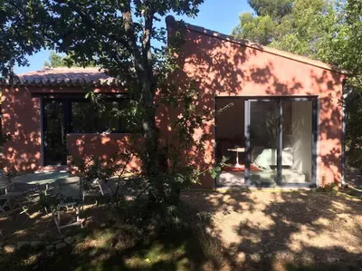 a small red house with a tree in front of it at Luberon : maison près de Joucas et Gordes in Joucas