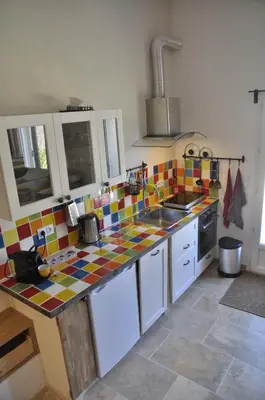 a kitchen with colorful tiles on the counter top at Gite Hardy in Velleron