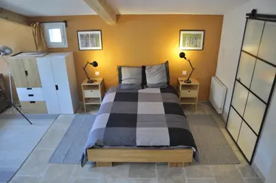 a bedroom with a large bed in a room at Gite Hardy in Velleron