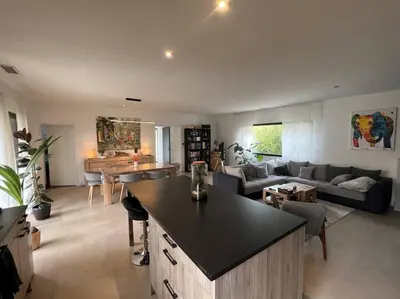 a kitchen and living room with a couch and a table at 3 bedrooms new house with heated swimming pool in Carpentras