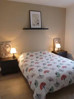 a bedroom with a bed with a comforter with umbrellas at 3 bedrooms new house with heated swimming pool in Carpentras