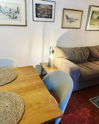 a living room with a couch and a table at Appartement centre village in Roussillon