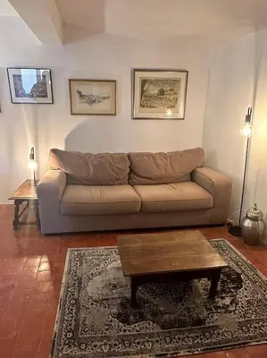 a living room with a couch and a coffee table at Appartement centre village in Roussillon
