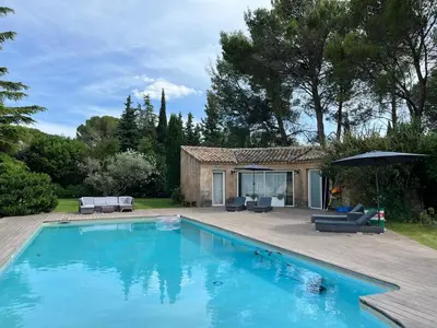 a swimming pool in front of a house at Le p’tit bonheur-Piscine chauffée-clim-Park in Carpentras