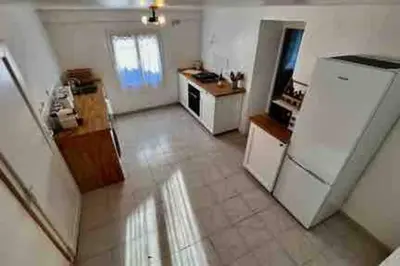 a kitchen with a white refrigerator in a room at Soleil d’ocre - Bastide à Roussillon in Roussillon