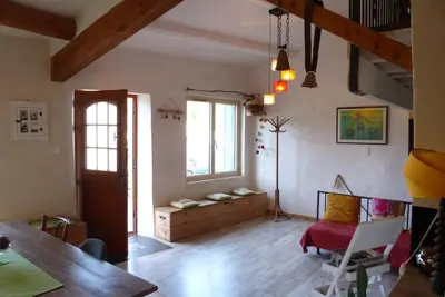 a living room with a table and a couch at Au Bregnat Vue du mont Ventoux in Bédoin