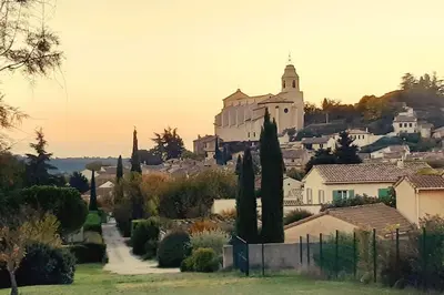 a view of a town with a castle on a hill at Au Bregnat Vue du mont Ventoux in Bédoin