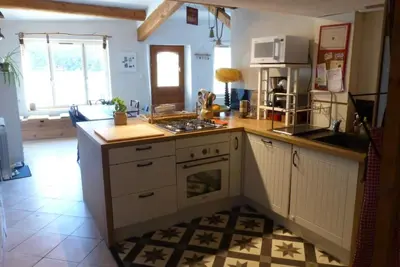 a kitchen with white cabinets and a stove top oven at Au Bregnat Vue du mont Ventoux in Bédoin