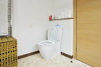 a bathroom with a white toilet in a room at Maison de ville moderne climatisée avec piscine in Morières-lès-Avignon