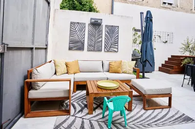 a patio with a couch and a table and chairs at Maison de ville moderne climatisée avec piscine in Morières-lès-Avignon
