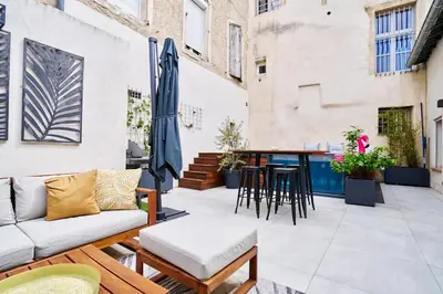 an outdoor patio with a couch and a table at Maison de ville moderne climatisée avec piscine in Morières-lès-Avignon