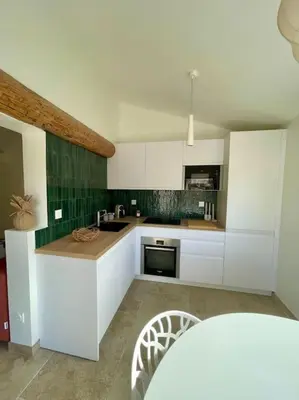 a kitchen with white cabinets and a counter top at Magnifique appartement + terrasse au cœur d’Aix in Aix-en-Provence