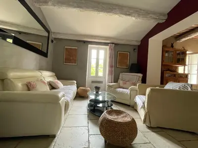 a living room with couches and a coffee table at LA BASTIDE FERREOL in La Motte-dʼAigues