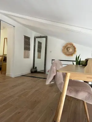 a dining room with a table and a mirror at Superbe maison avec jacuzzi in Ventabren