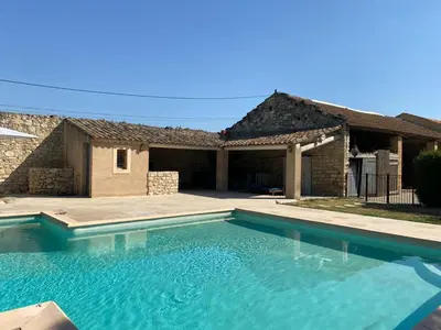 a large swimming pool in front of a house at Mas Gardane in Pernes-les-Fontaines