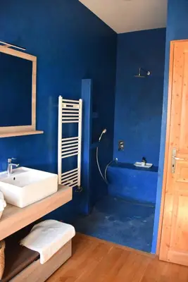 a blue bathroom with a sink and a tub at Mas Gardane in Pernes-les-Fontaines