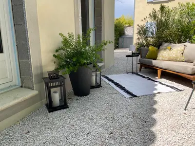 a porch with a couch and a potted plant at Joli gite en Provence avec piscine in Aubignan