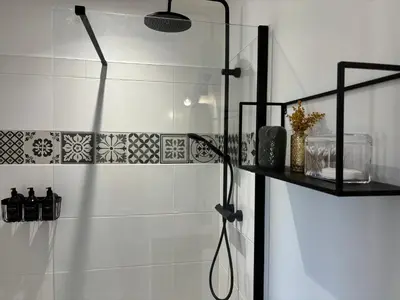 a bathroom with a shower with a glass door at Joli gite en Provence avec piscine in Aubignan