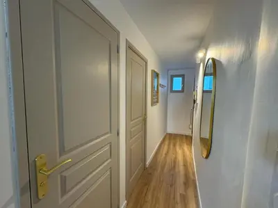 an empty hallway with a door and a mirror at Les Bouteilles - 1 chambre hyper centre - 6p - Wifi in Aix-en-Provence