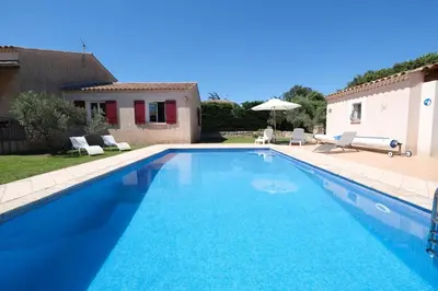 a large blue swimming pool in front of a house at pretty detached villa with private swimming pool, in Aureille, in the alpilles - 8 people in Aureille