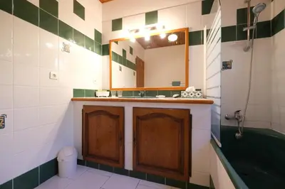 a bathroom with a sink and a mirror and a tub at pretty detached villa with private swimming pool, in Aureille, in the alpilles - 8 people in Aureille