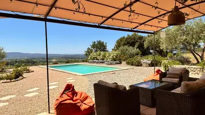 a patio with chairs and a swimming pool at La Bergerie des Pottiers. Mas rénové climatisation Piscine in Crillon-le-Brave