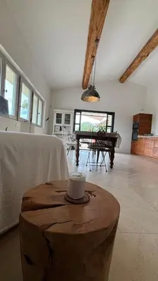 a living room with a table and a piano at La Bergerie des Pottiers. Mas rénové climatisation Piscine in Crillon-le-Brave