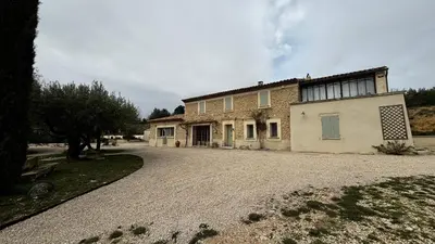 a house with a gravel driveway in front of it at La Bergerie des Pottiers. Mas rénové climatisation Piscine in Crillon-le-Brave