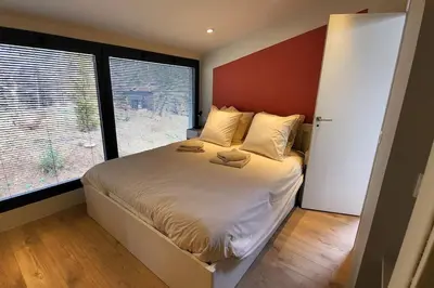 a bedroom with a bed with two pillows on it at LOU BRISOU in Saint-Saturnin-les-Apt