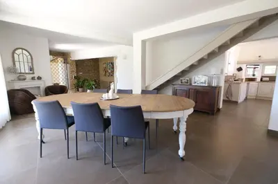 a kitchen and dining room with a table and chairs at Slpendid villa with heated pool and Jacuzzi for 12 people in Saint-chamas in Saint-Chamas