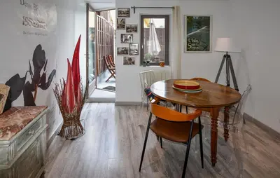 a dining room with a wooden table and a table and chairs at Beautiful Home In L'isle-Sur-La-Sorgue in LʼIsle-sur-la-Sorgue