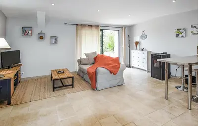 a living room with a couch and a table at Nice Home In La-Roque-Sur-Pernes in La Roque-sur-Pernes
