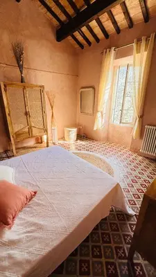 a large bed in a room with a window at Le Mas de Bonnety - Magnifique mas 12 personnes au Pied du Mont Ventoux in Saint-Pierre-de-Vassols